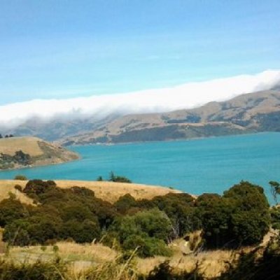 a large body of water with a mountain in the background