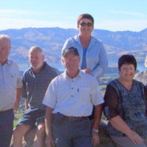 a group of people standing in front of a mountain