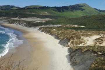 a person riding a wave on top of a rocky mountain
