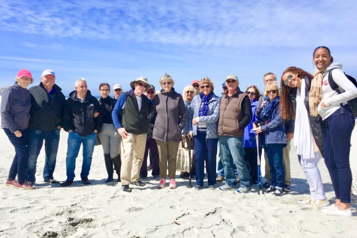 a group of people standing in front of a crowd posing for the camera