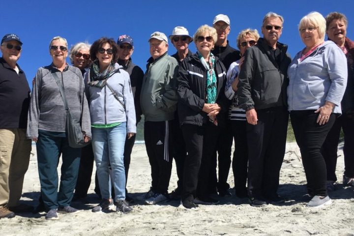 a group of people standing in front of a crowd posing for the camera